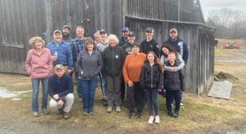 Hicks Family standing by their barn